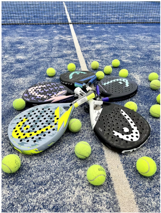 Padel rackets and balls on a blue court